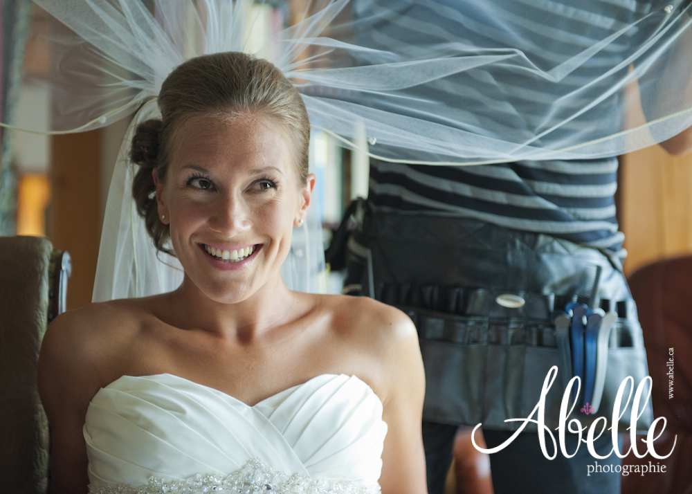Smiling bride during the wedding veil setting.