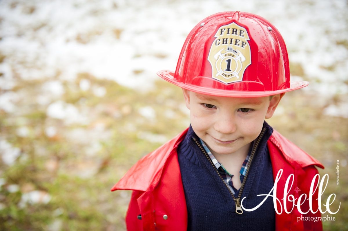 Young child portrait in fireman outfit.